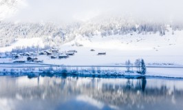lake-by-snow-covered-hills-captured-foggy-day.jpg